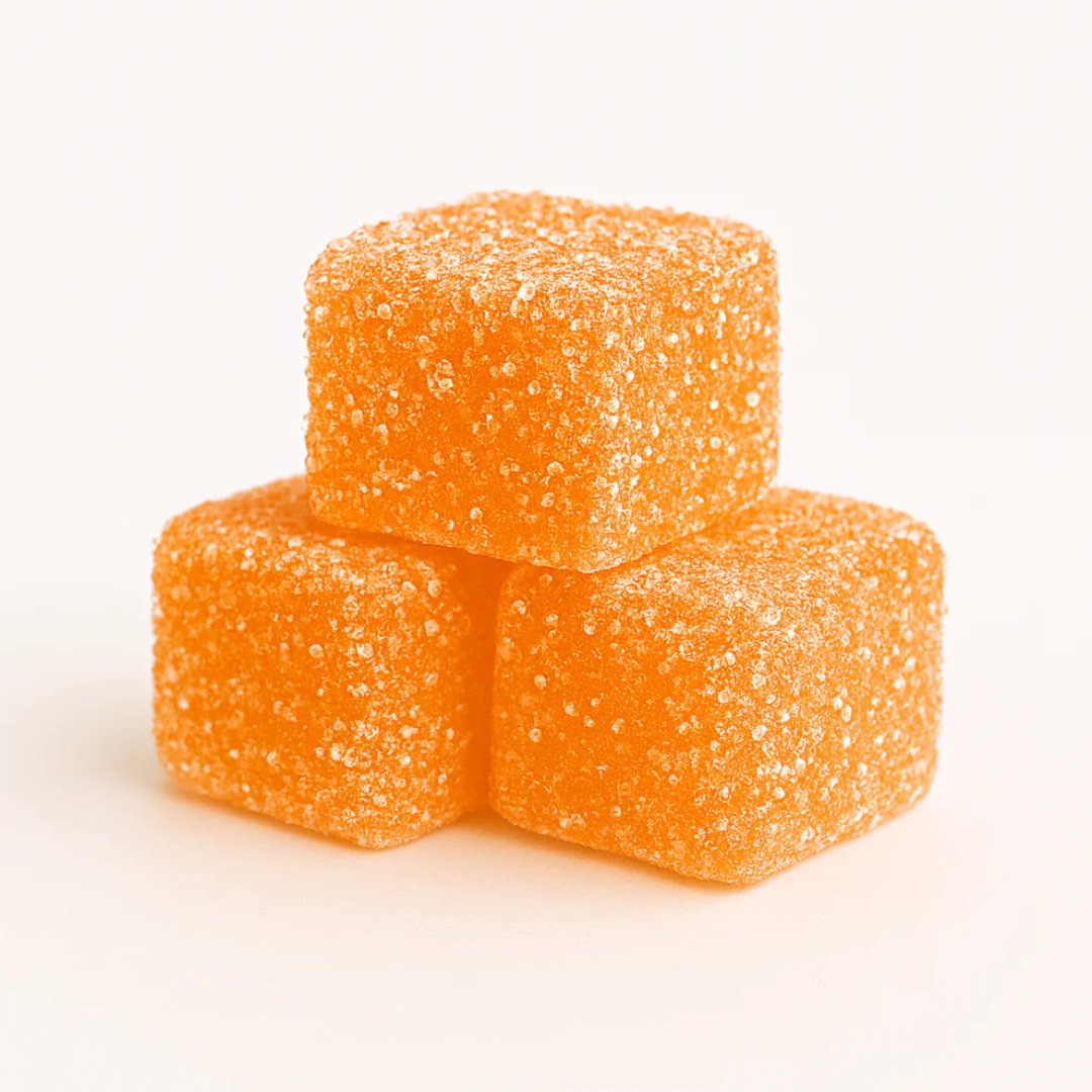 Three mango dream gummy cubes stacked on a white background sleep gummies CBD and CBN