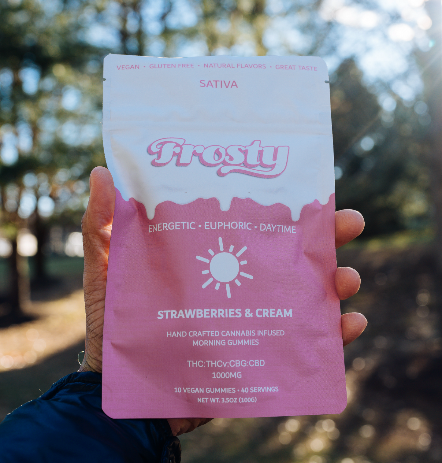 Frosty Hemp Co Morning Delta 9 THC Gummies – Strawberries & Cream 1000mg Sativa pouch held outdoors, energetic euphoric daytime formula