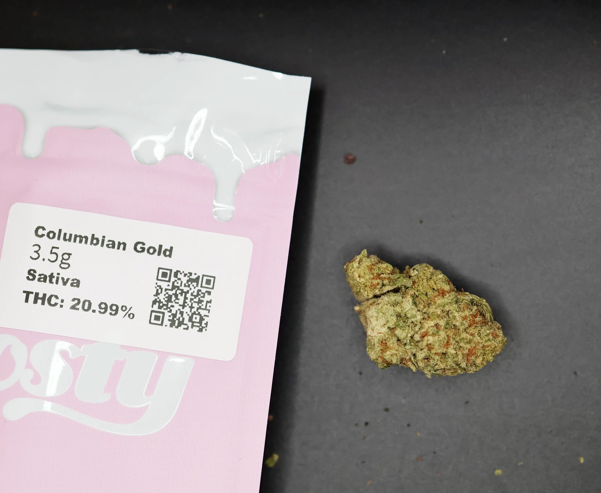 Cannabis package labeled 'Columbian Gold' with a small amount of thca flower on the side