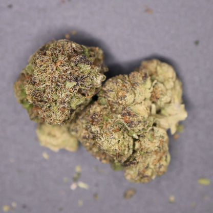 Close-up of two pistachio runtz cannabis buds on a gray background