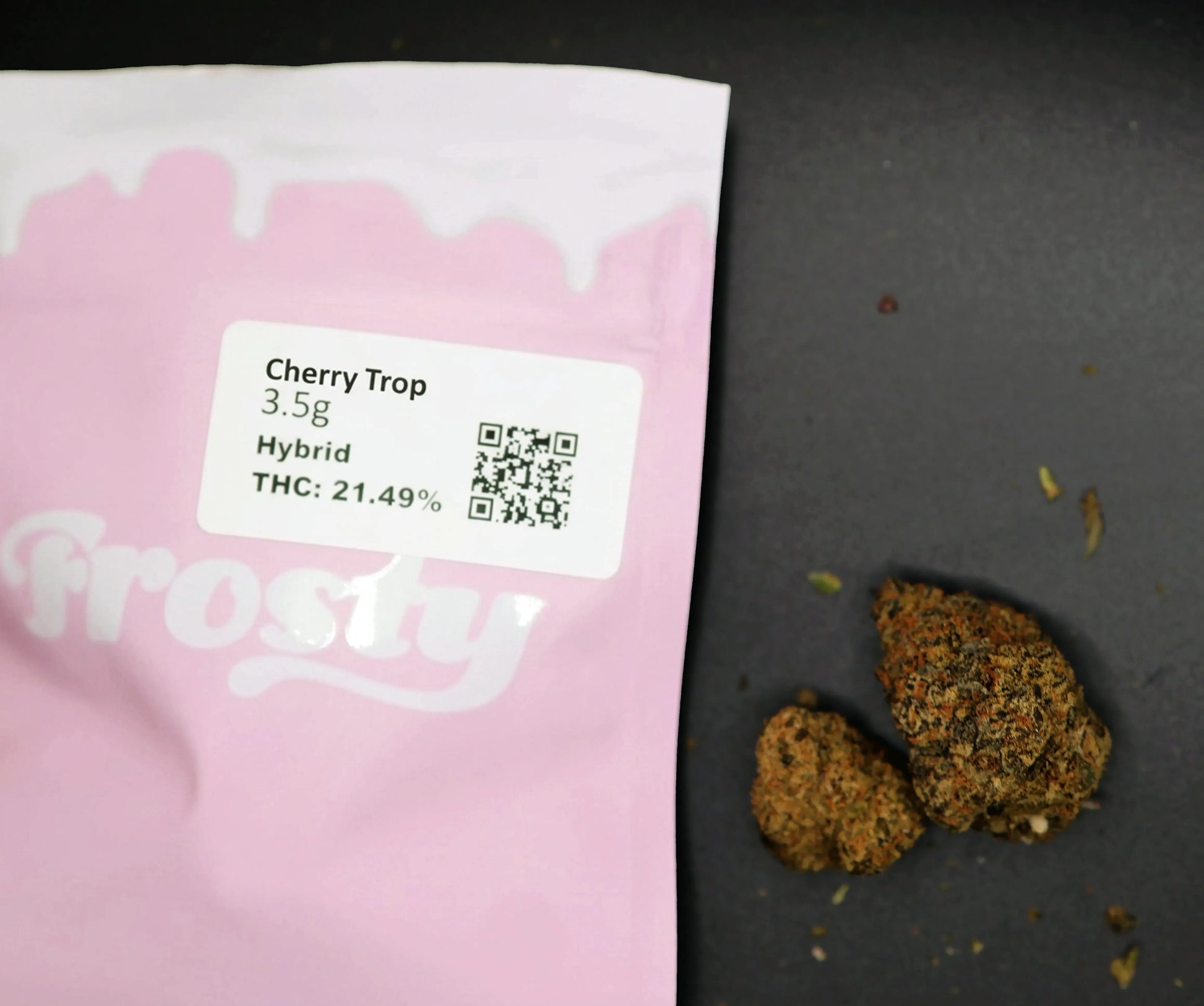 Pink cherry trop packaging with 'frosty' branding, containing cannabis buds and a label with product details.