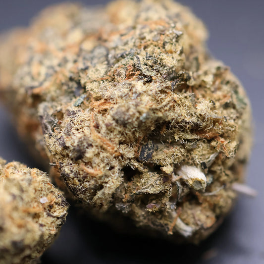 Close-up of a cherry trop thca bud with a dark background