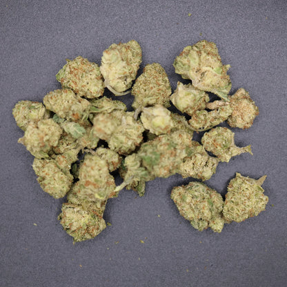 pile of smalls buds on a flat surface, columbian gold thca flower 