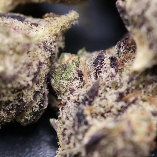 close up of high thca showing crystals on permanent marker smalls buds with dark background
